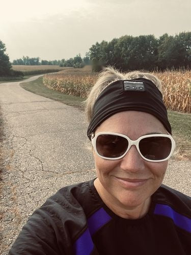 Person wearing a black headband outdoors