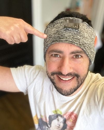 Person showing the controls on a grey headband