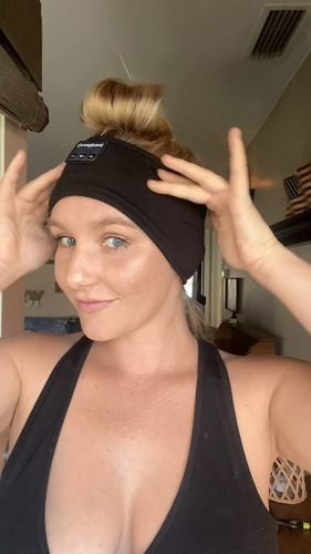 Person wearing a black Bluetooth headband